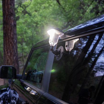 A Devos Light Mount by SeaSucker on a car window.