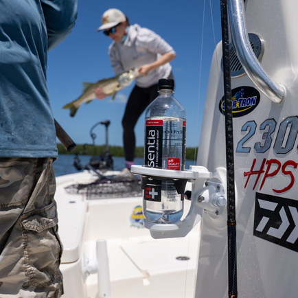 A SeaSucker Universal 1-Cup Holder attached to the side of a boat.