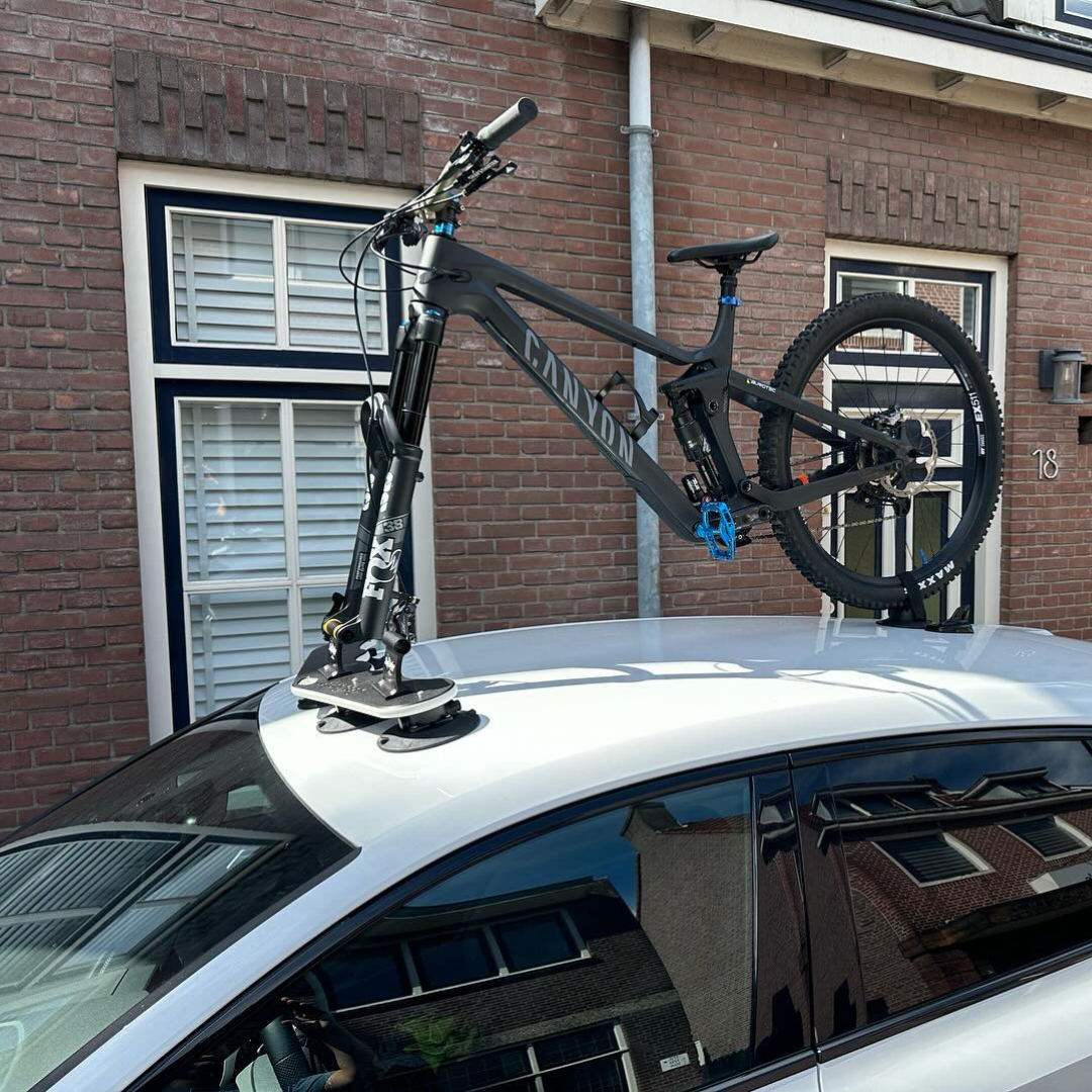 Bomber - 3 Bikes lifestyle image showing mountain bike mounted to roof of car