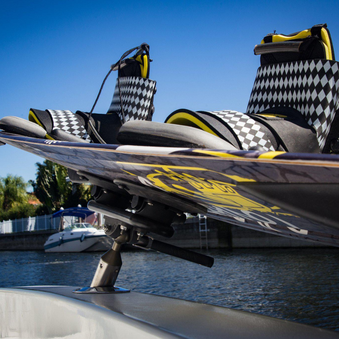 Ozy Mount lifestyle photo on boat holding wakeboard